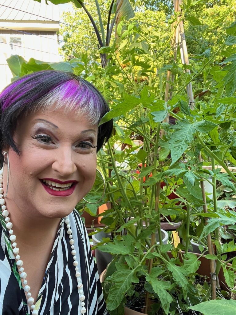 Tyffanie with tomato plant in a pot